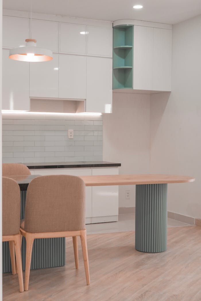 Stylish modern kitchen with minimalist design featuring sleek furniture and soft lighting.