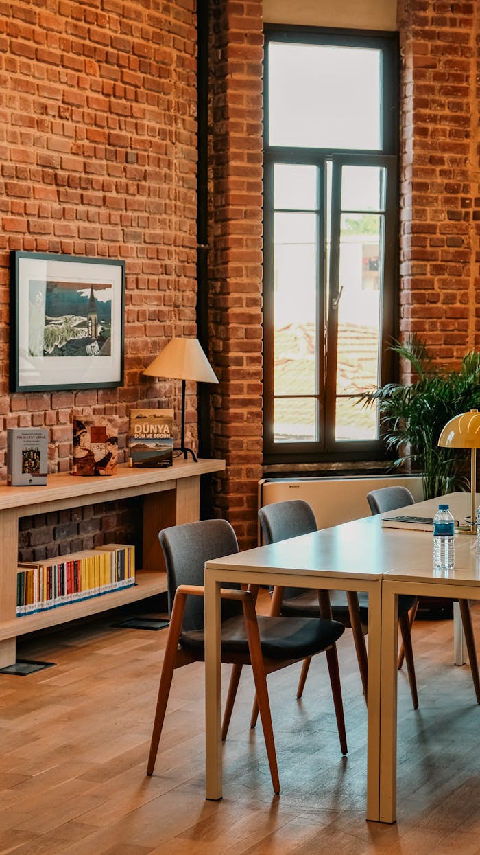 Warm, modern industrial office space with brick walls and contemporary furniture, perfect for creativity.