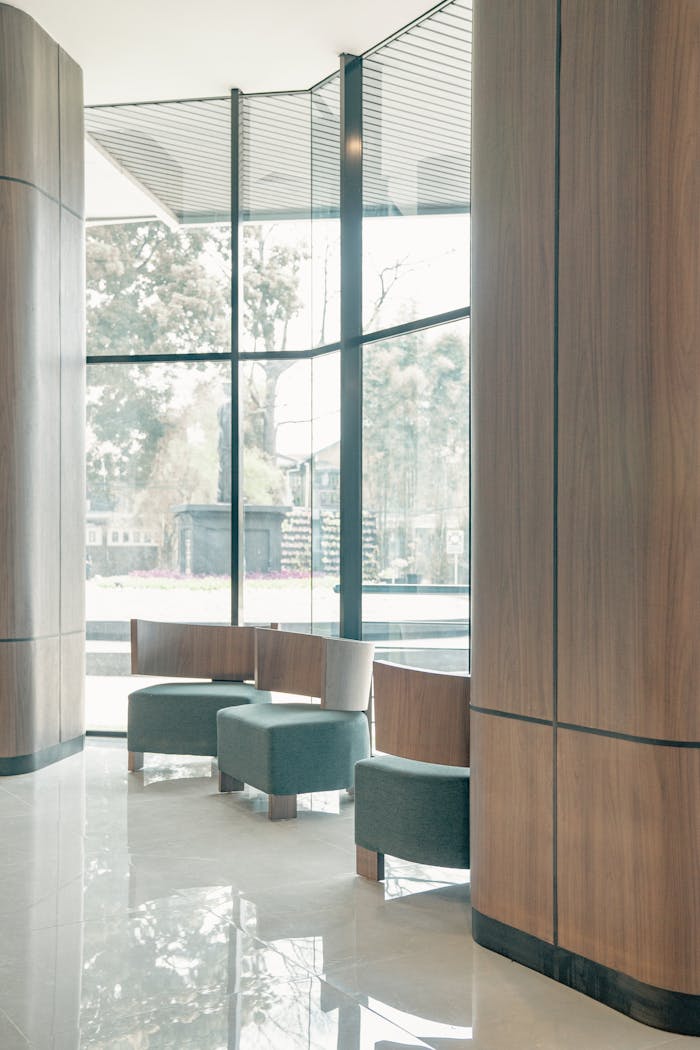 Bright and spacious modern interior with large windows and minimalist seating.